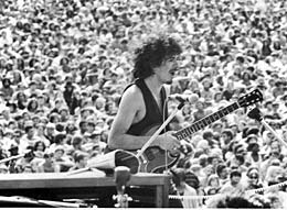 Carlos Santana with crowds at Woodstock 1969 by David Marks